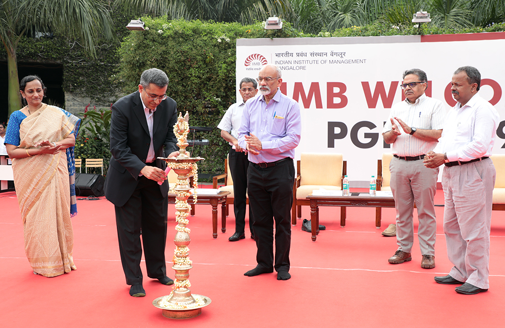 The chief guest, Amit Sharma, Global COO, IBM, GBS, lights the inaugural lamp as IIMB Director Professor G Raghuram, Chair of Admissions Professor G Sabarinathan, Chair of the PGP Programme Professor Padmini Srinivasan, Dean of Academic Programmes Professor Abhoy K Ojha and Dean Faculty Professor Gopal Naik look on.